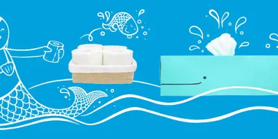Rollos de papel higiénico y una caja de almacenaje de rollos casera con forma de ballena azul y una sirena dibujada