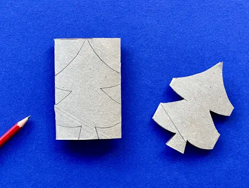 Una madre y su hija pequeña haciendo manualidades con rollos de papel higiénico para Navidad.